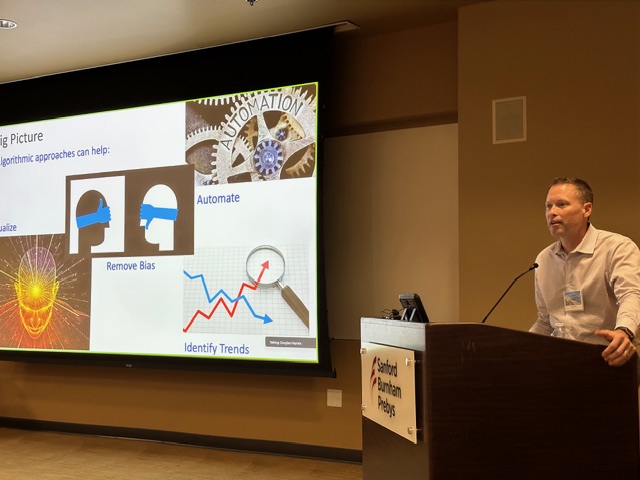 Lecturer at the podium presenting on algorithmic approaches in cytometry