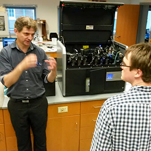 Instructor explaining flow cytometer optics